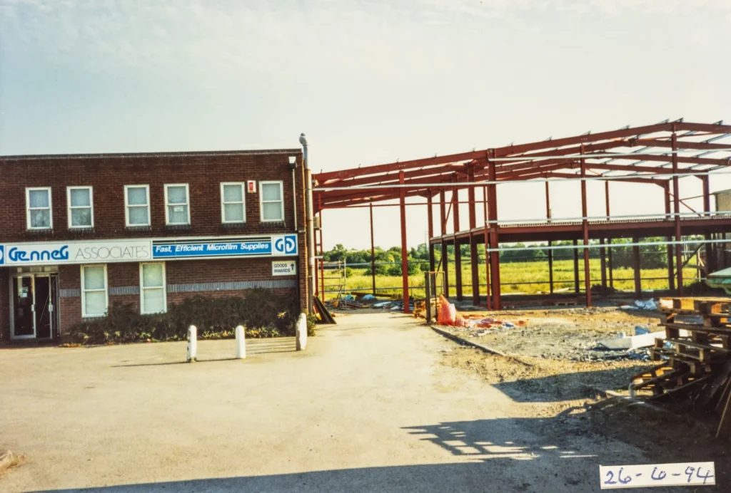A photograph of the Genneg building with the warehouse framework being constructed.