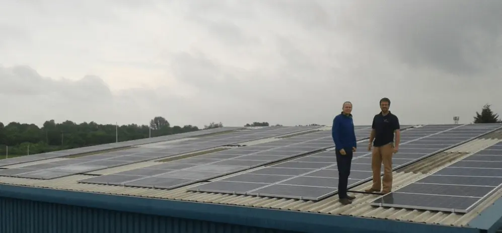 A photograph of Paul Negus and Chris Elwell on top of the Genus building with the new solar panels.