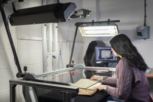studio technician operating a Zeutschel book cradle.
